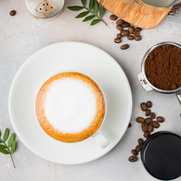 Coffee with latte art in a white ceramic cup on a table