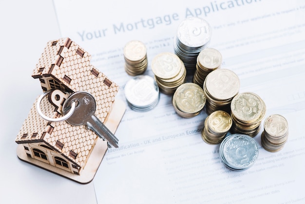 Free photo coins and key on sheet of mortgage application