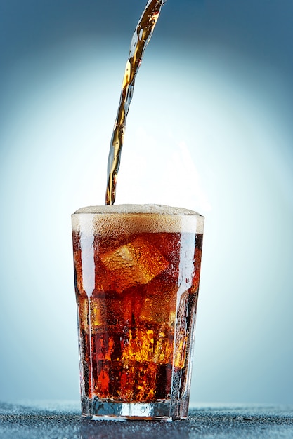 Cola pouring in a glass