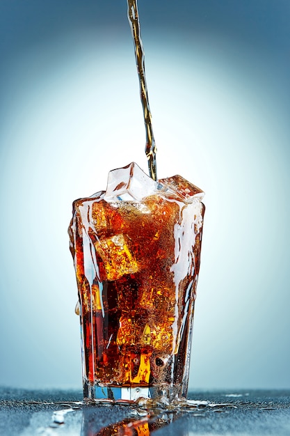 Cola pouring in a glass