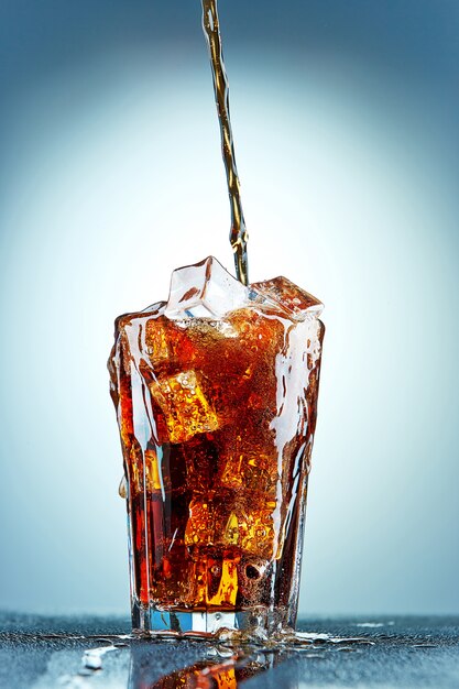 Cola pouring in a glass