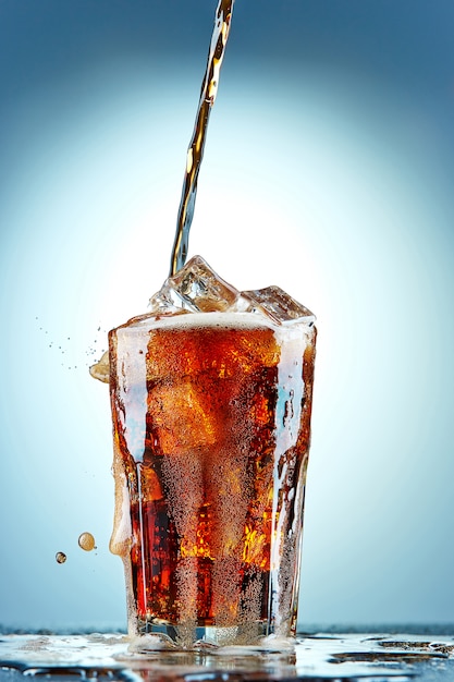 Cola pouring in a glass