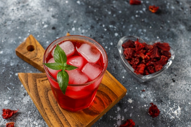 Free Photo cold brew hibiscus tea with ice and basil leaves.