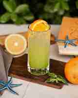 Free photo cold lemon cocktail with orange slice