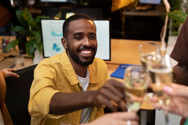 Free Photo colleagues clinking glasses close up