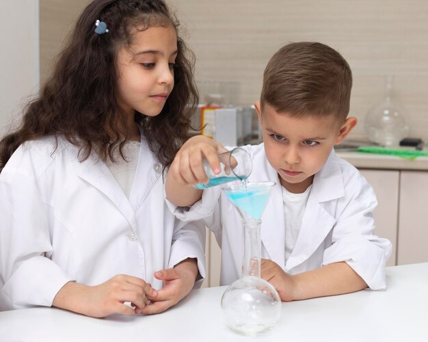 Colleagues doing a chemical experiment at school