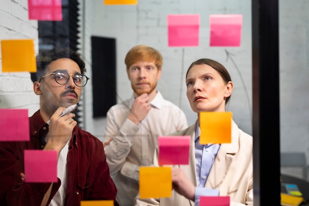 Colleagues looking at post its medium shot