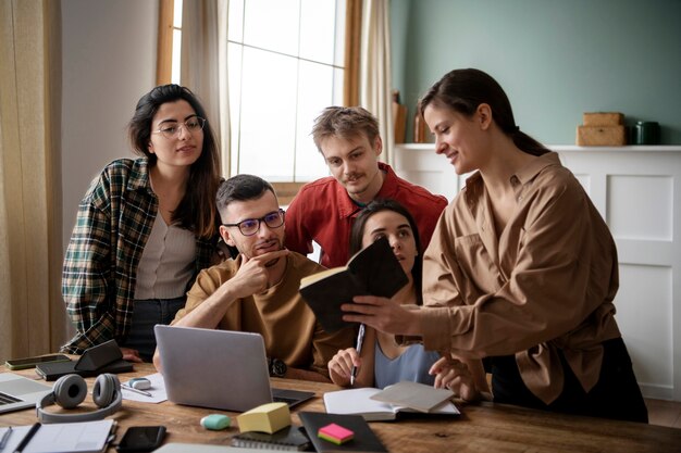 Colleagues reading from a book during study session