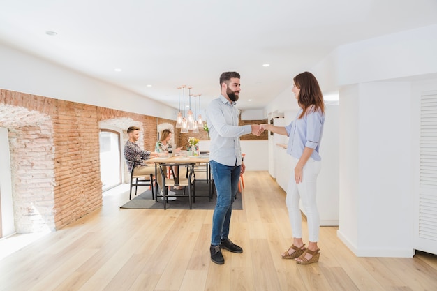 Colleagues shaking hands in modern office