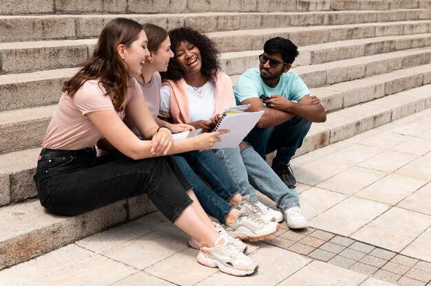 Colleagues studying together in front of their college before an exam