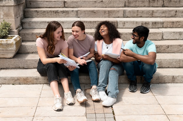 Colleagues studying together in front of their college before an exam