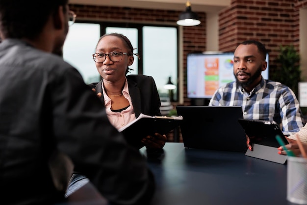 Free photo colleagues team working on company paperwork, doig teamwork to analyze documents and online research information. planning corporate presentation with data charts, job collaboration.