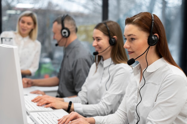 Free Photo colleagues working together in a call center with headphones