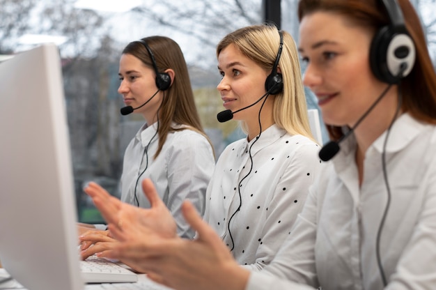 Colleagues working together in a call center with headphones