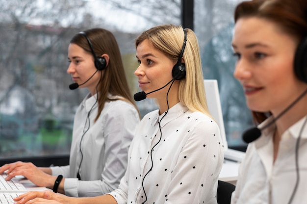 Free photo colleagues working together in a call center with headphones