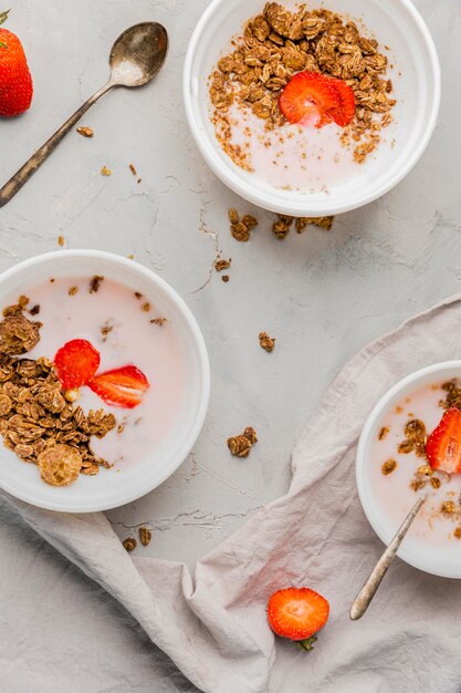 Collection of breakfast bowls with granola and strawberry