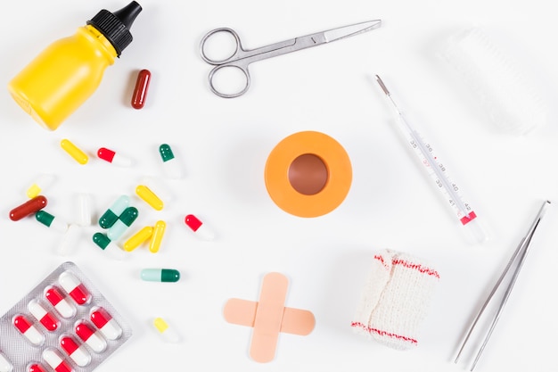 Collection of medical bottle; pills; bandage and thermometer isolated on white background