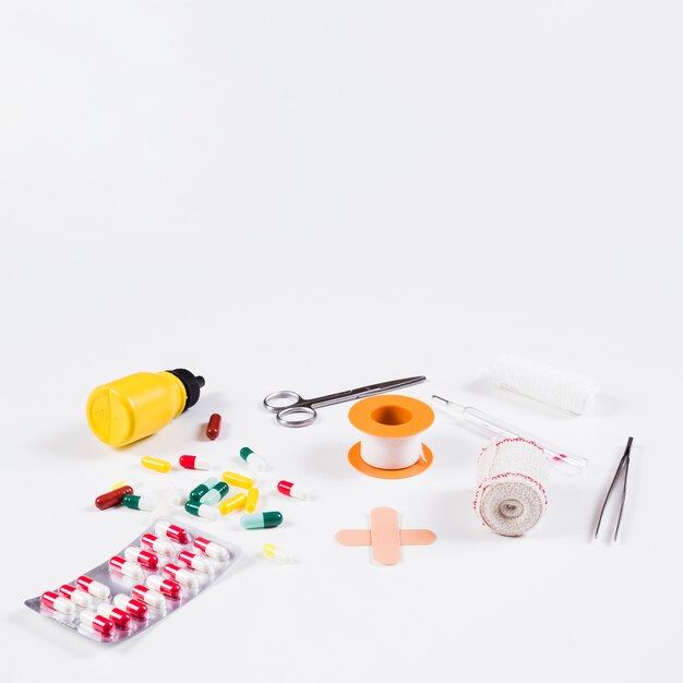 Collection of medical equipments and capsules on white background