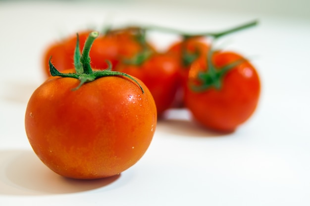 Free photo collection of tomatoes with a light shadows, isolated on white,