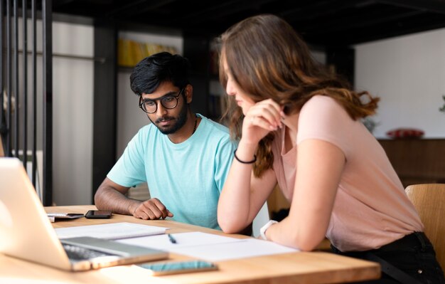 College girl and boy studying together