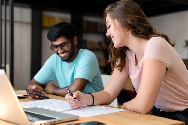 College girl and boy studying together