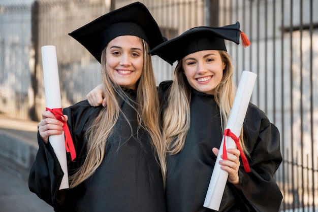 Free photo college graduates smiling at the camera