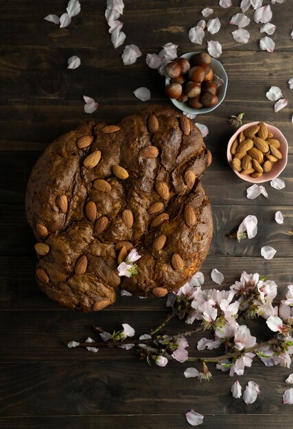 Colomba with almonds and flowers flat lay