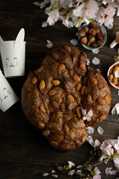 Colomba with almonds and flowers top view