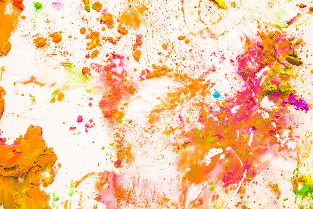 Color dust particles splattered on white background