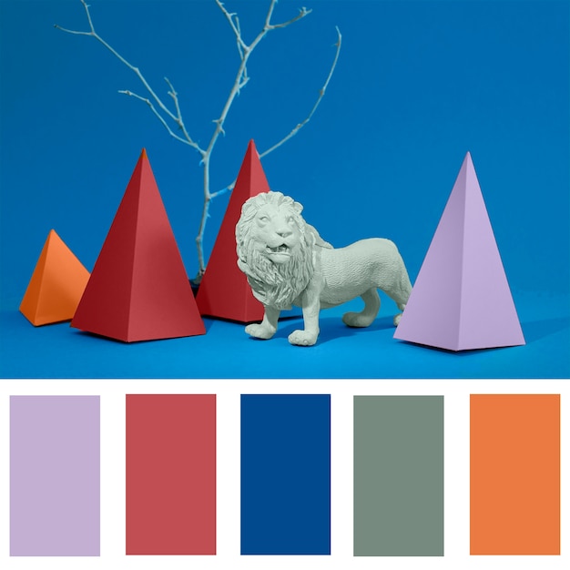 Free Photo color swatch over lion figurine and paper pyramids