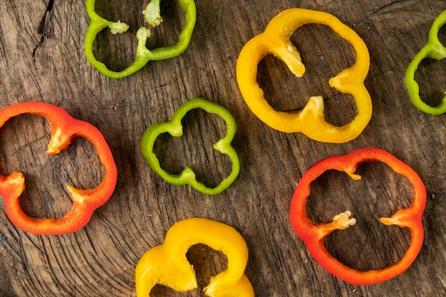 Colored bell pepper slided on wood background