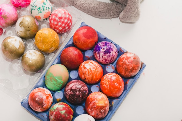 Free photo colored eggs in cartons