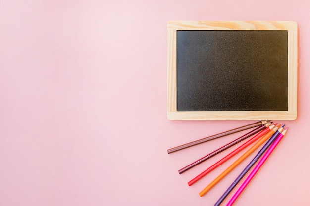 Colored pencils near chalkboard