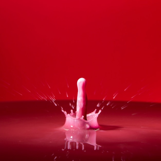 Free Photo colored pink droplet in red water