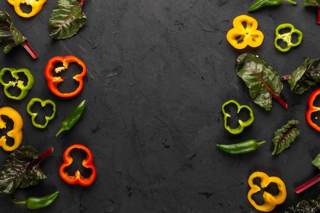 Colored vegetables fresh ripe and sliced on dark desk