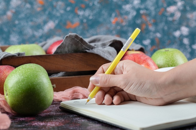 Colorful apples and a recipe book aside