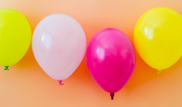 Free photo colorful balloons on orange background