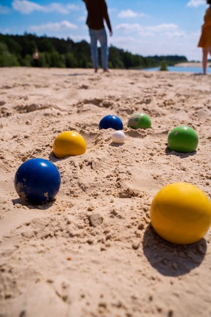 Colorful balls on sand high angle