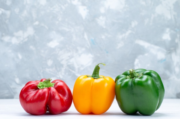 Free Photo colorful bell-peppers lined on white desk, vegetable spice hot food meal ingredient product