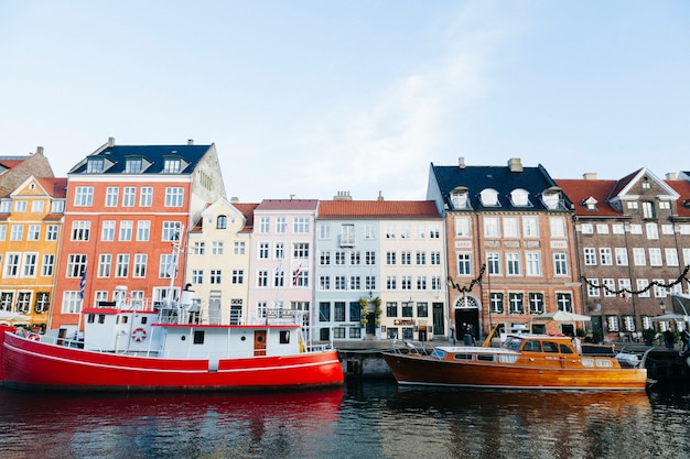 Free Photo colorful boats and old city buildings