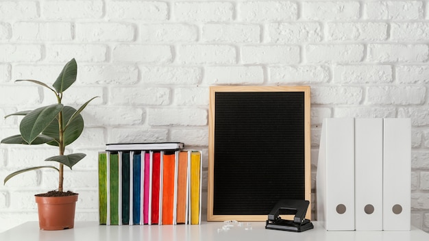 Colorful books and plant on table