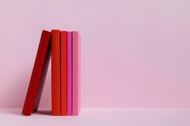 Free Photo colorful books with pink background