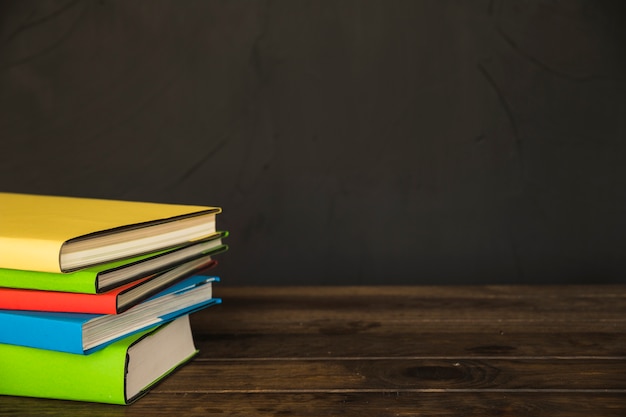 Colorful books on wooden table