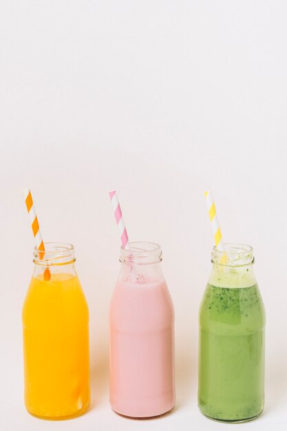 Colorful bottles with fruit smoothies