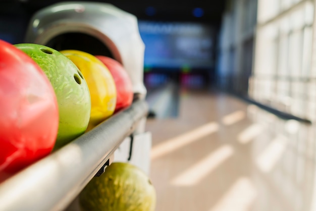 Colorful bowling balls on blurred alley