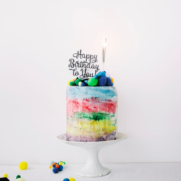 Free photo colorful cake with writing and sparklers