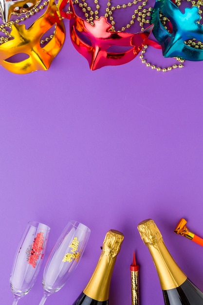 Colorful carnival masks with champagne bottles