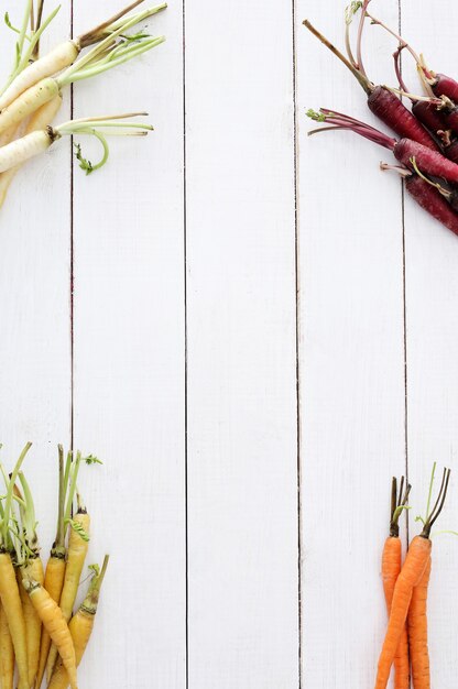 Colorful carrots on wooden table background