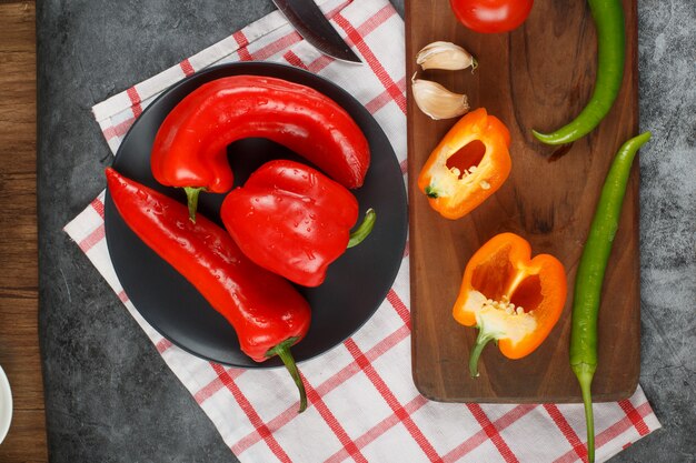 Colorful chili peppers on a wooden board.