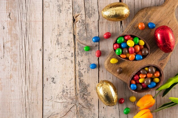 Colorful chocolate Easter eggs on wooden table